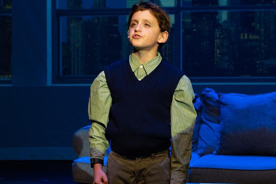 young boy performing onstage in elf the musical 