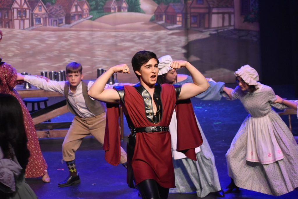 Gaston flexing muscles