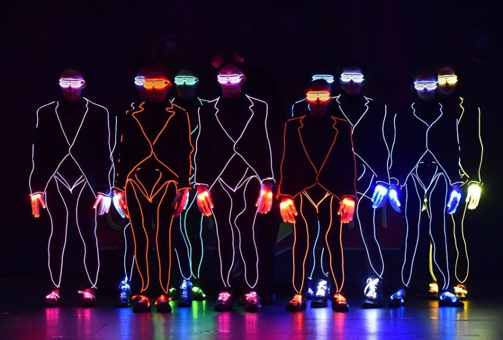 light up characters onstage in LED costumes