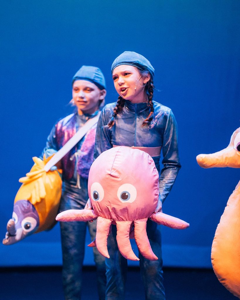 Girl as dressed as baby octopus onstage