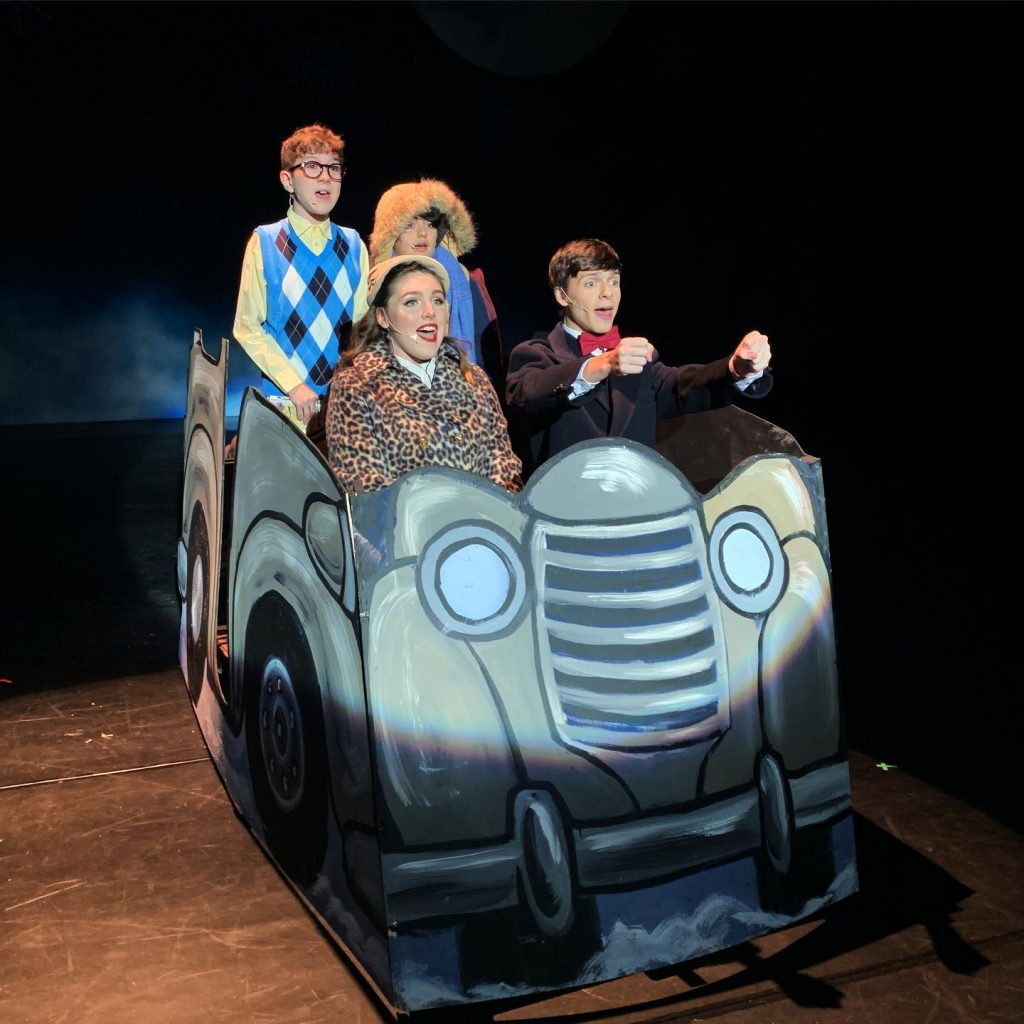 Christmas story family in a fake car onstage