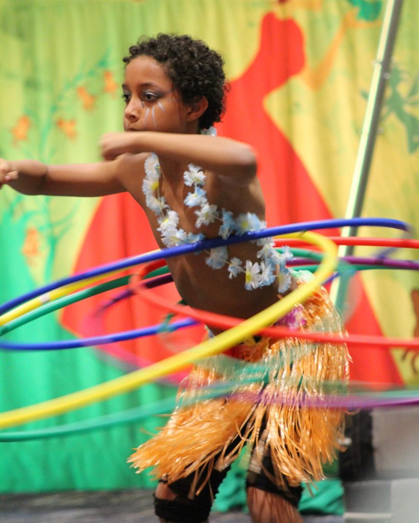 Young boy hula hooping 