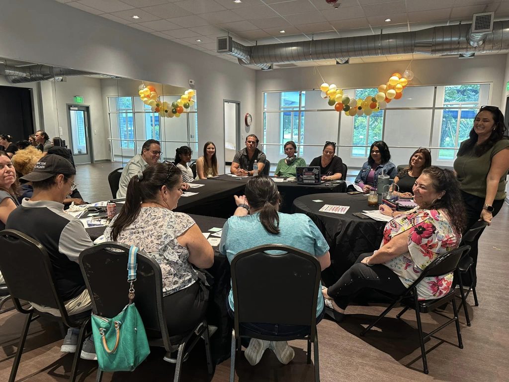 First spotlight circle of friends meeting at FLCT. Adults gather around tables to meet. 